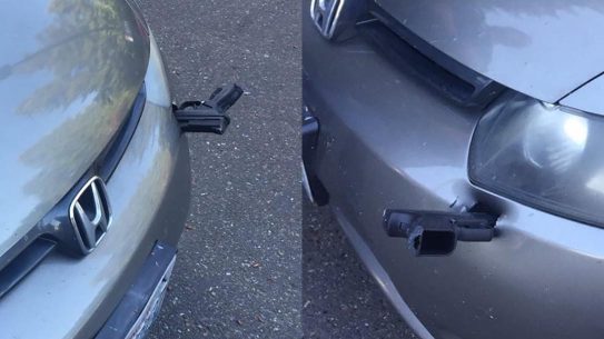 gun car bumper, handgun lodges into bumper