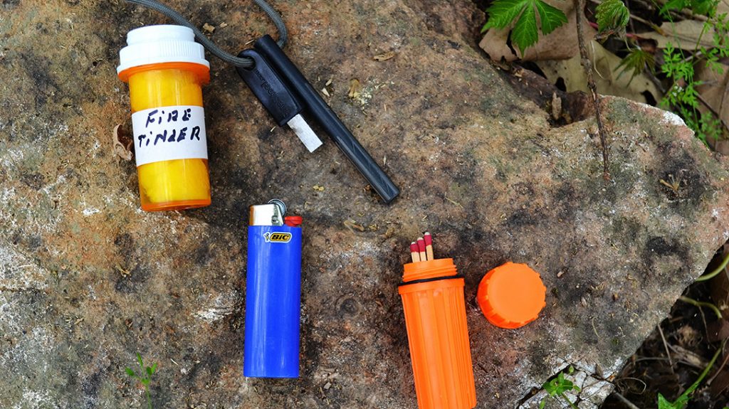 Fire can be essential to survival. The author suggests the survival kit contain three sources of fire and proven all weather tinder.