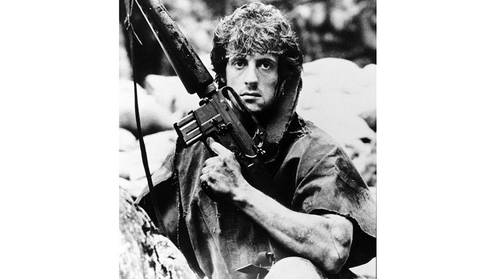 Rambo posing with early type M16 rifle from Vietnam era. 